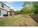 Large backyard features a covered patio, seating area, and playground, perfect for Gathering activities at 461 Timberleaf Rd, Canton, GA 30115
