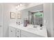 Bright bathroom with dual vanity, framed mirrors, and a tiled shower with glass doors at 461 Timberleaf Rd, Canton, GA 30115
