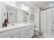 Bathroom featuring double sinks with modern faucets, white cabinets, and a walk-in shower with a curtain at 461 Timberleaf Rd, Canton, GA 30115