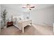 Bright primary bedroom with a ceiling fan and a wooden bed frame, complemented by neutral carpet at 461 Timberleaf Rd, Canton, GA 30115
