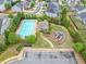 Aerial shot of community pool and nearby playground area with parking and beautiful landscaping at 461 Timberleaf Rd, Canton, GA 30115