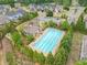 Aerial view of a community pool area with lounge chairs, trees, and a nearby playground at 461 Timberleaf Rd, Canton, GA 30115