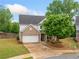 Inviting two-story home with brick facade, lush front lawn, and a cozy porch with rocking chairs at 461 Timberleaf Rd, Canton, GA 30115