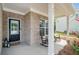 Inviting front porch with rocking chairs, brick accents, and a charming entrance door at 461 Timberleaf Rd, Canton, GA 30115