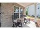Charming front porch with rocking chairs and brickwork offers a relaxing entrance to the home at 461 Timberleaf Rd, Canton, GA 30115