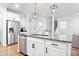 Kitchen island featuring granite countertops, stainless steel appliances, and modern pendant lighting at 461 Timberleaf Rd, Canton, GA 30115