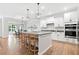 Modern kitchen featuring a large island, stainless steel appliances, and open dining area at 461 Timberleaf Rd, Canton, GA 30115