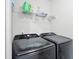 Modern laundry room includes front load washer and dryer set and practical shelving at 461 Timberleaf Rd, Canton, GA 30115