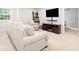Comfortable living area with plush sofas, a modern entertainment center, and neutral carpet at 461 Timberleaf Rd, Canton, GA 30115