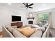 Cozy living room with a fireplace, comfortable seating, and plenty of natural light at 461 Timberleaf Rd, Canton, GA 30115