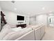 Bright living room with a large sectional sofa, an entertainment center, and a bookshelf at 461 Timberleaf Rd, Canton, GA 30115