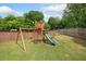Backyard playground with swing set, slide and climbing structure for ' entertainment at 461 Timberleaf Rd, Canton, GA 30115