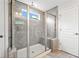 Modern shower showcasing gray tile, built-in bench, and glass enclosure in a bright bathroom at 461 Timberleaf Rd, Canton, GA 30115