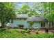 View of the home's backyard, featuring a patio area, grill, and lush greenery at 495 Ramsdale Dr, Roswell, GA 30075