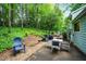 Exterior features a back patio with a table and chairs, ideal for outdoor dining at 495 Ramsdale Dr, Roswell, GA 30075