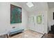 Welcoming foyer featuring tiled flooring, a comfortable bench, and a decorative front door at 495 Ramsdale Dr, Roswell, GA 30075
