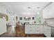 Open kitchen-dining area with white cabinetry, granite countertops, and modern pendant lighting at 495 Ramsdale Dr, Roswell, GA 30075