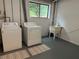 Bright laundry room with a window, sink, washer, and dryer at 495 Ramsdale Dr, Roswell, GA 30075