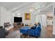 Comfortable living room featuring vaulted ceilings, brick fireplace, hardwood floors, and blue sofa at 495 Ramsdale Dr, Roswell, GA 30075
