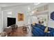 Bright living room featuring vaulted ceilings, modern decor, hardwood floors, and cozy blue sofa at 495 Ramsdale Dr, Roswell, GA 30075