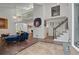 Open living area with stairs to loft, vibrant art, and staircase leading to the upper level at 495 Ramsdale Dr, Roswell, GA 30075