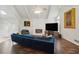 Spacious living room with a fireplace, hardwood floors, and modern decor at 495 Ramsdale Dr, Roswell, GA 30075