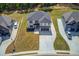 New home featuring a modern design, well-manicured lawn, and long driveway at 51 Deer Canyon Dr, Auburn, GA 30011