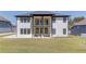 The back of this home has a covered patio, large lawn and modern windows at 51 Deer Canyon Dr, Auburn, GA 30011
