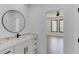 Stylish bathroom with marble countertops, a sleek round mirror, and black hardware at 51 Deer Canyon Dr, Auburn, GA 30011