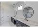 Elegant bathroom featuring double vanity with marble countertops, modern fixtures, and a stylish circular mirror over each sink at 51 Deer Canyon Dr, Auburn, GA 30011