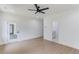 Open bedroom with hardwood floors, ceiling fan, and doorway to the bathroom with marble floors at 51 Deer Canyon Dr, Auburn, GA 30011