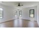Modern bedroom with light wood floors, ceiling fan, and large windows offering natural light and outdoor views at 51 Deer Canyon Dr, Auburn, GA 30011