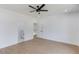 Bright bedroom with hardwood floors, ceiling fan, and open doorway leading to the bathroom at 51 Deer Canyon Dr, Auburn, GA 30011