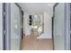Grand foyer with light wood floors, a staircase with glass railings, and contemporary design at 51 Deer Canyon Dr, Auburn, GA 30011