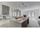 Unfinished kitchen with island, modern lighting, and view to large windows at 51 Deer Canyon Dr, Auburn, GA 30011