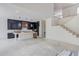 Unfinished kitchen featuring a spacious island, pendant lighting, and access to the staircase at 51 Deer Canyon Dr, Auburn, GA 30011