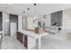 Unfinished kitchen and view to living room with island, modern lighting, and view to living room at 51 Deer Canyon Dr, Auburn, GA 30011