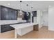 Modern kitchen with black cabinets, a large island, and shelving at 51 Deer Canyon Dr, Auburn, GA 30011