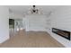 Open living room with modern light fixture, wood flooring, and chic fireplace design at 51 Deer Canyon Dr, Auburn, GA 30011