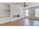 Elegant living room with modern built-ins, shiplap accent wall, and large windows, blending style with natural light at 51 Deer Canyon Dr, Auburn, GA 30011