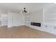 Stylish living area featuring wood floors, a modern fireplace, built-in shelving, and contemporary lighting at 51 Deer Canyon Dr, Auburn, GA 30011