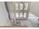 Living room with modern lighting fixture and large windows offering an outdoor view at 51 Deer Canyon Dr, Auburn, GA 30011