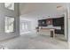 Unfinished living room with a large picture window and access to the kitchen at 51 Deer Canyon Dr, Auburn, GA 30011