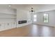 Bright living room with a fireplace and sleek cabinets and shelves in a modern design at 51 Deer Canyon Dr, Auburn, GA 30011