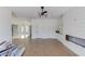 Bright, open living room with hardwood floors, modern lighting, and custom built-ins with shiplap accent wall at 51 Deer Canyon Dr, Auburn, GA 30011
