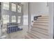 Bright, unfinished living room with large windows, stairs, and natural light at 51 Deer Canyon Dr, Auburn, GA 30011