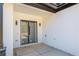A covered patio with a white brick wall and a black framed sliding glass door at 51 Deer Canyon Dr, Auburn, GA 30011