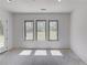 Bright room featuring a trio of windows offering scenic backyard views at 51 Deer Canyon Dr, Auburn, GA 30011