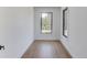 Bright room featuring hardwood floors, white walls, and a large window with a view of the trees at 51 Deer Canyon Dr, Auburn, GA 30011