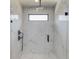 Modern shower with marble tiling, a rain shower head, and a glass door at 51 Deer Canyon Dr, Auburn, GA 30011